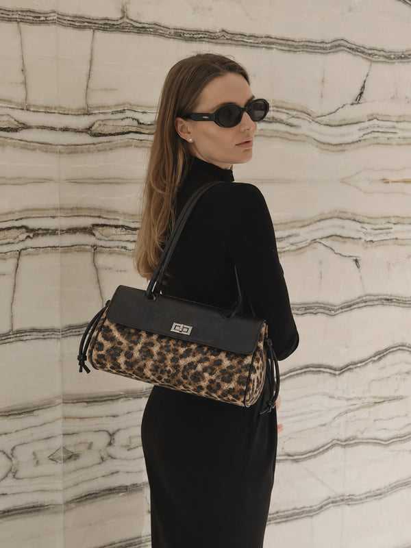 Compact two-tone quilted shoulder bag with black leather-look flap, silver turn-lock clasp, diamond-quilted body, side