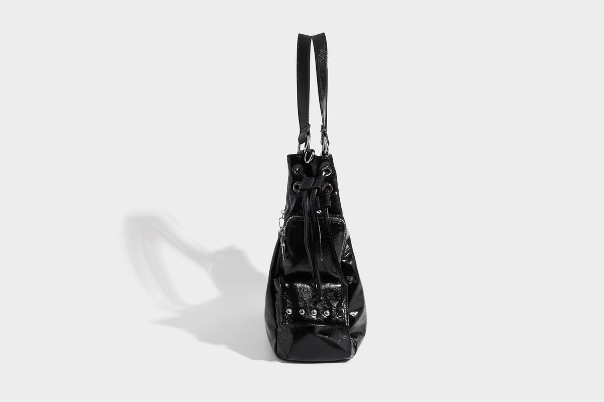 Glossy crinkled leather-look tote bag with silver grommet lace-up front detail, dual top handles, and detachable shoulder