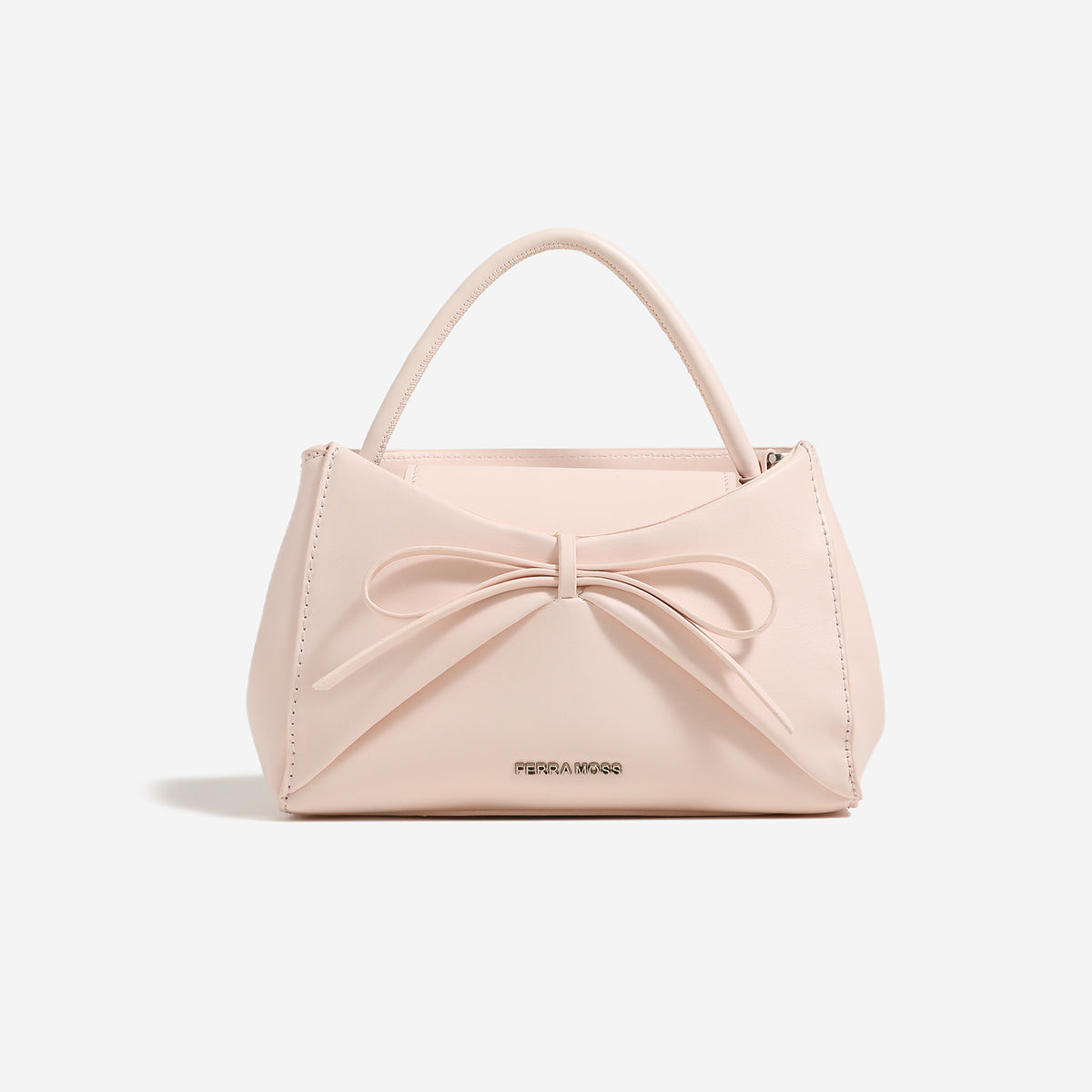 Small structured trapezoid handbag with a three-dimensional front bow, short top handle, and detachable shoulder strap