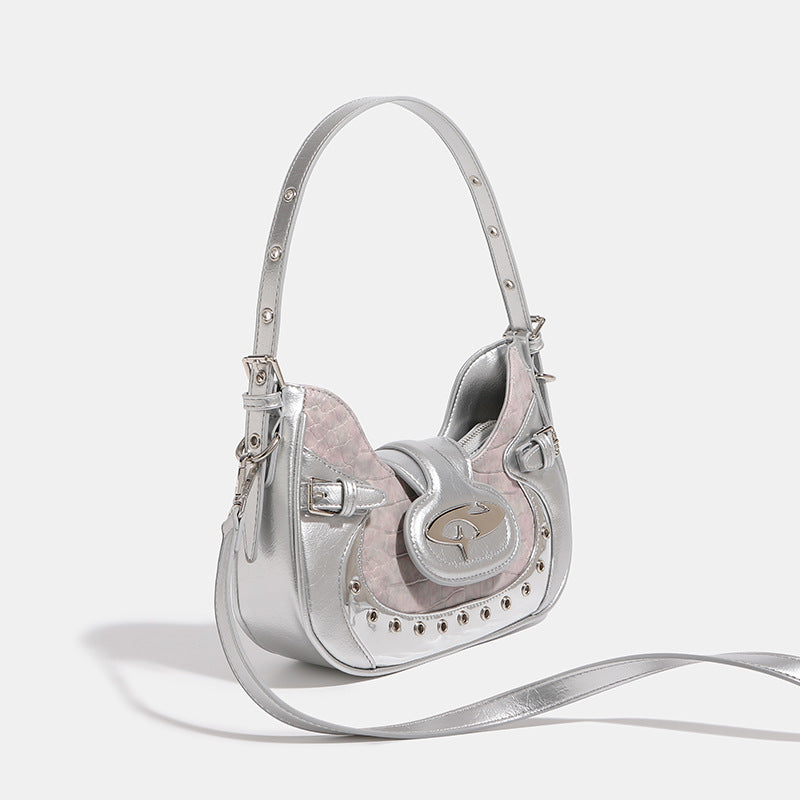 Compact croc-embossed leather-look shoulder bag with silver grommet trim, buckle strap detail, and four-point star turn-lock