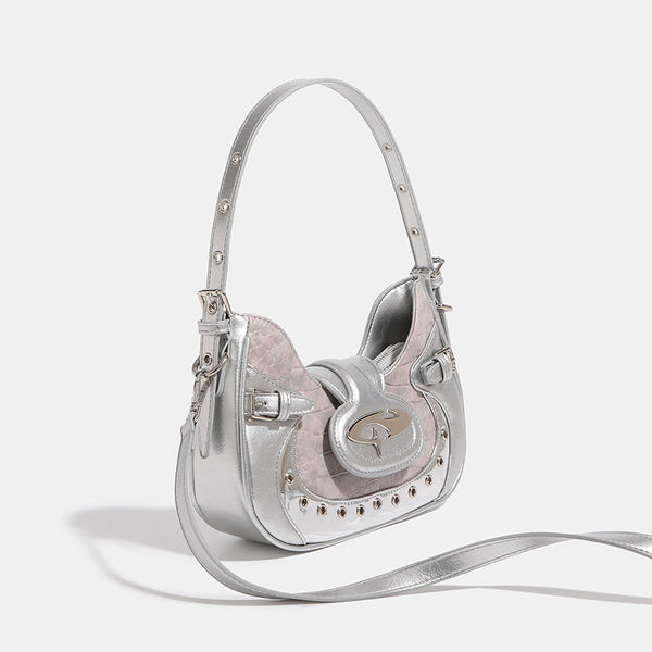 Compact croc-embossed leather-look shoulder bag with silver grommet trim, buckle strap detail, and four-point star turn-lock