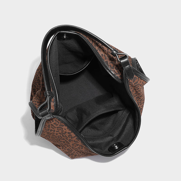 Slouchy brown leopard jacquard hobo tote bag with black leather-look trim and single shoulder strap, shown with black, detail