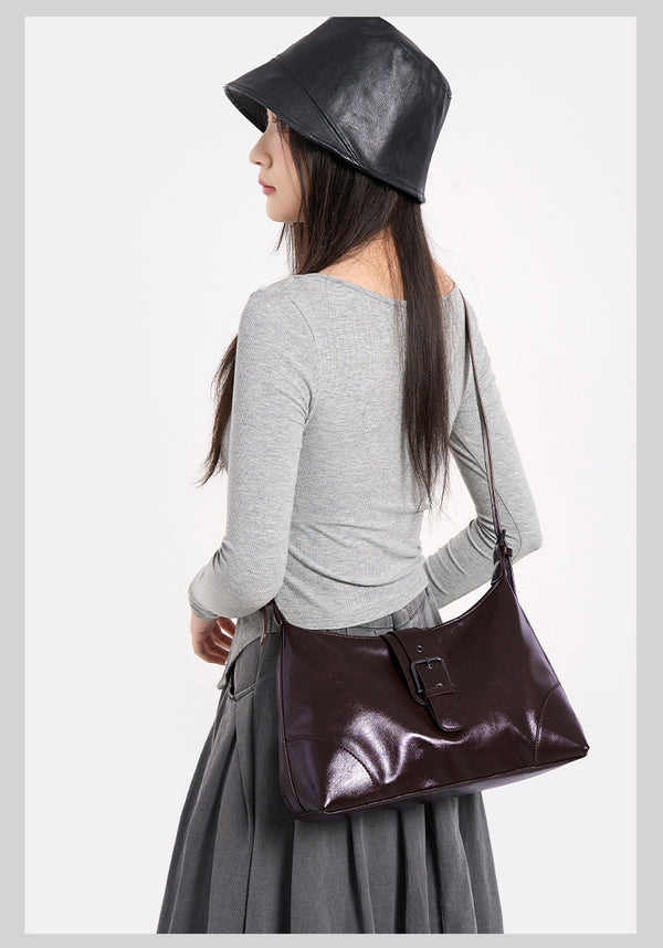 Glossy dark brown slouch hobo shoulder bag with front buckle strap panel and long adjustable single strap, detail view 20