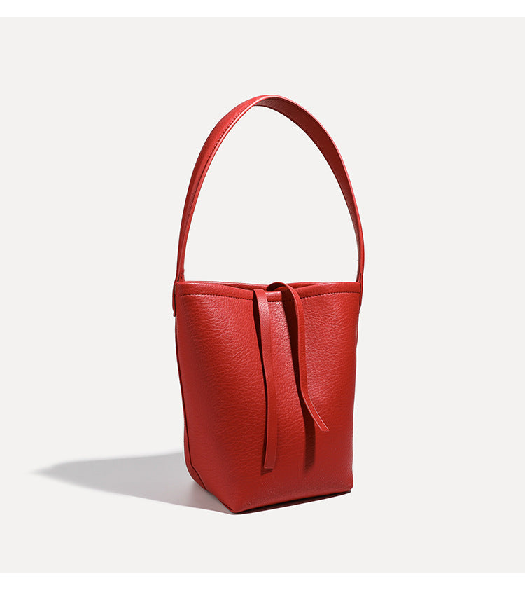 Mini tapered bucket bag in pebbled leather-look finish with front tie straps and single shoulder strap, detail view 16