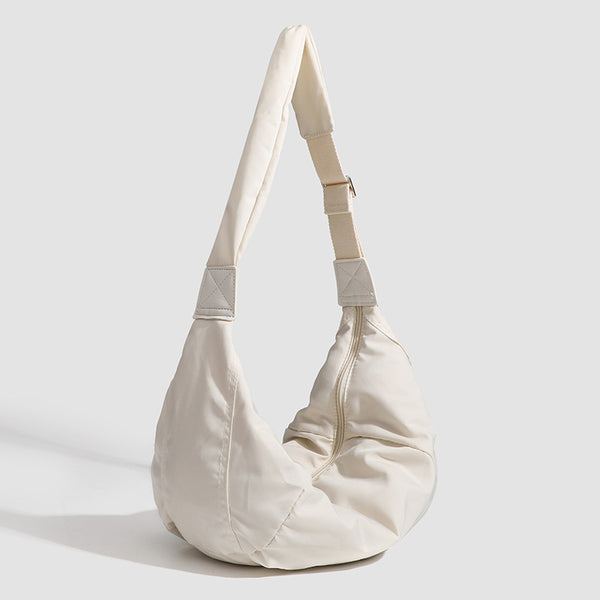 Large crescent sling shoulder bag in gathered fabric with zip closure and adjustable strap, detail view 3