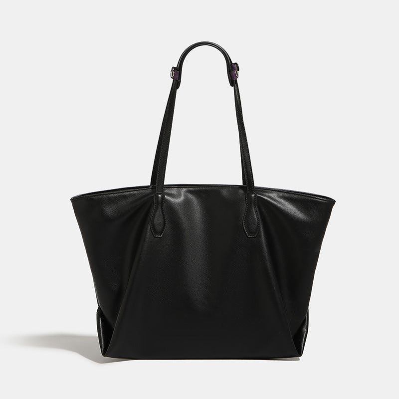 Large black leather-look trapezoid tote bag with double shoulder straps and purple accent hardware, front view