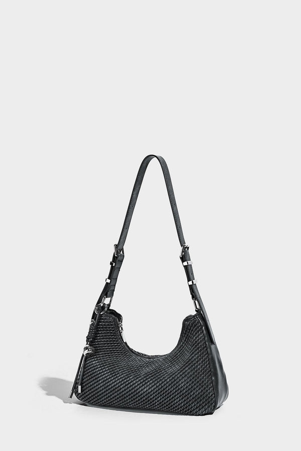 Woven crescent hobo shoulder bag with smooth side panels, zip-top closure, silver-tone charm hardware, and adjustable, detail