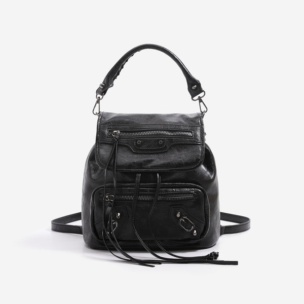 Mini flap backpack handbag with silver stud hardware, front zip pockets, and drawstring tassels, detail view 6