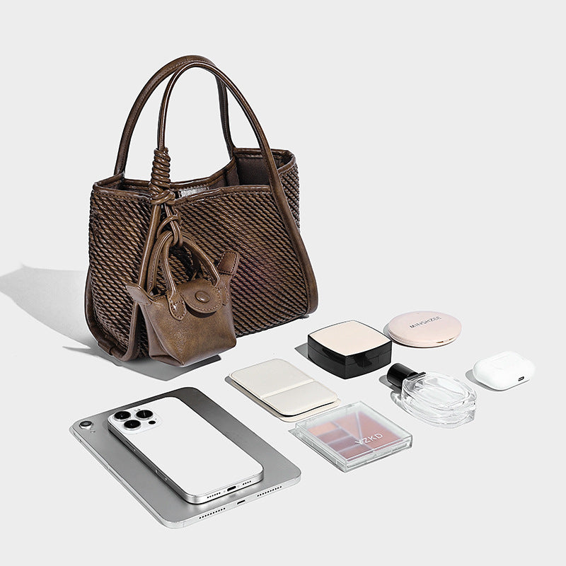 Large structured woven rope-texture tote bag with smooth leather-look trim, knotted dual top handles, detachable mini front
