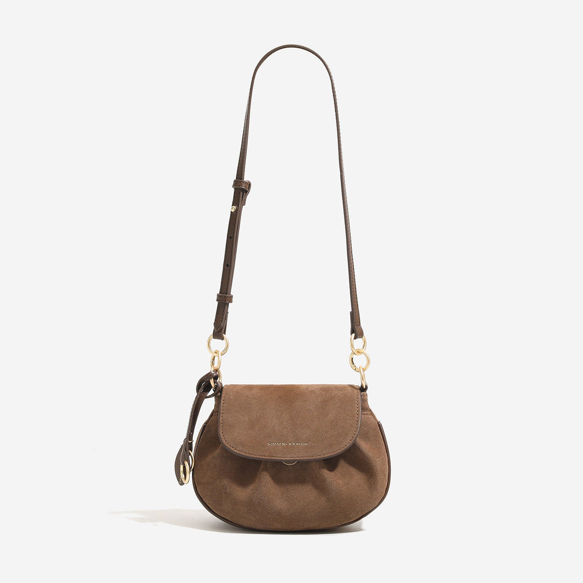 Small flap saddle crossbody bag with gold-tone ring hardware and adjustable strap, detail view 8