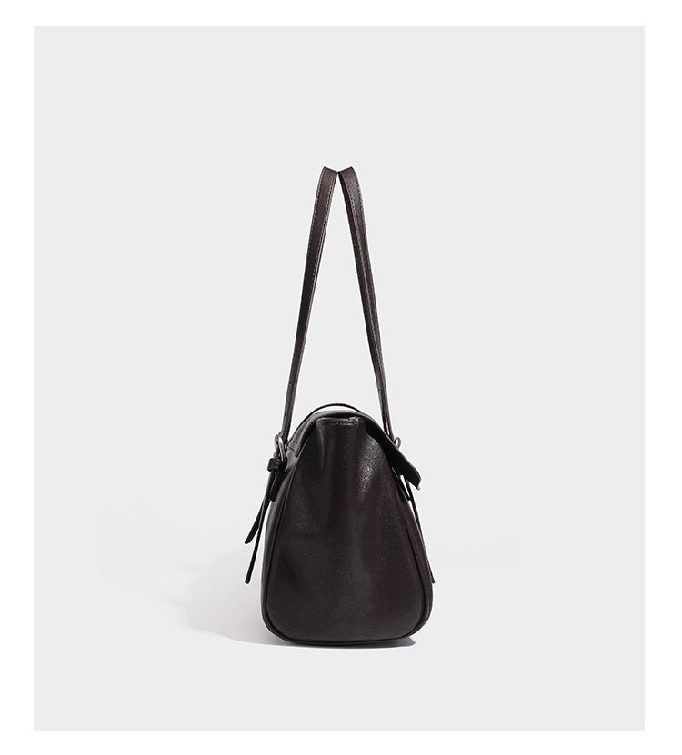 Large structured vintage-style tote bag with flap-front turn-lock closure, twin buckle straps, and double shoulder handles