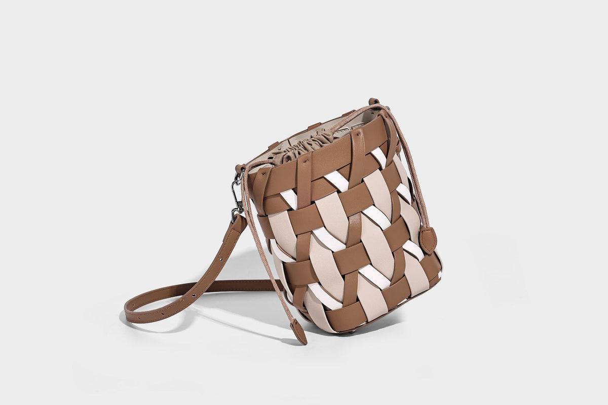 Small woven lattice bucket bag in tan and cream leather-look strips with drawstring top and detachable crossbody strap