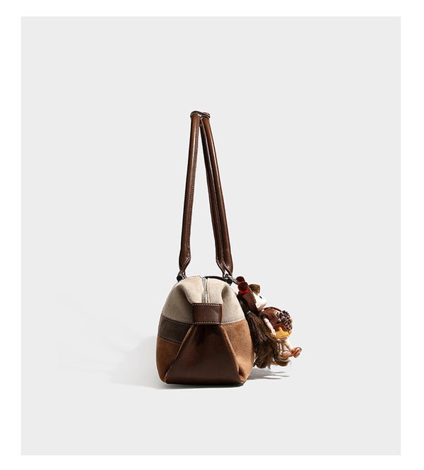 Patchwork suede-look barrel shoulder bag in brown, rust, tan, beige, and gray panels with double leather-look straps and