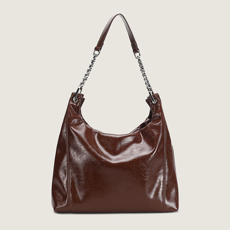 Glossy crinkled leather-look slouchy hobo bag with silver chain-and-leather shoulder strap and open top, detail view 7
