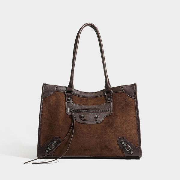 Large structured tote bag with matte suede-like body, smooth leather-look trim, front zip pocket, stud hardware, and