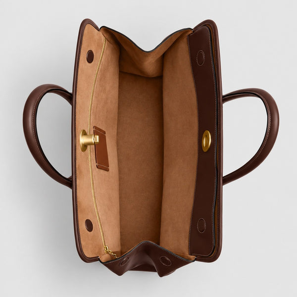 Structured leather-look tote bag with three gold-tone turn-lock closures and double rolled top handles, detail view 4