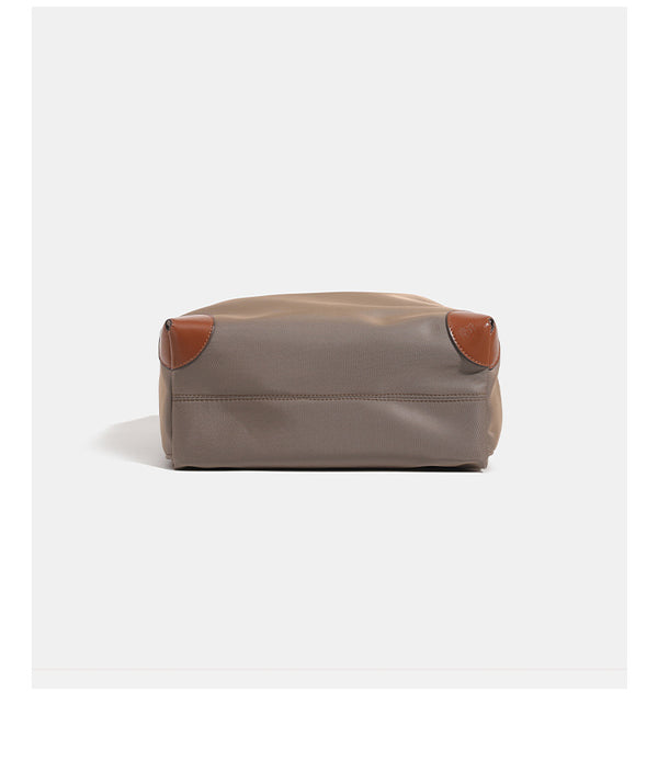 Soft rectangular nylon convertible backpack handbag with leather-look trim, snap-flap closure, top carry handles, padded