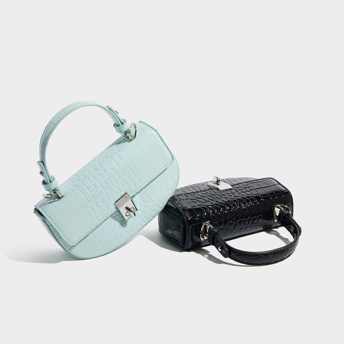 Glossy croc-embossed mini saddle bag with silver-tone turn-lock clasp and short top handle, detail view 2
