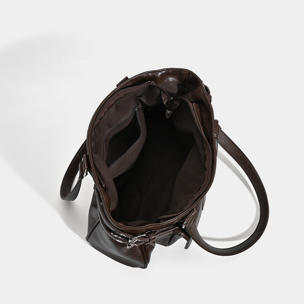 Large glossy leather-look tote bag with front flap pocket, silver-tone buckle hardware, dual top handles and detachable
