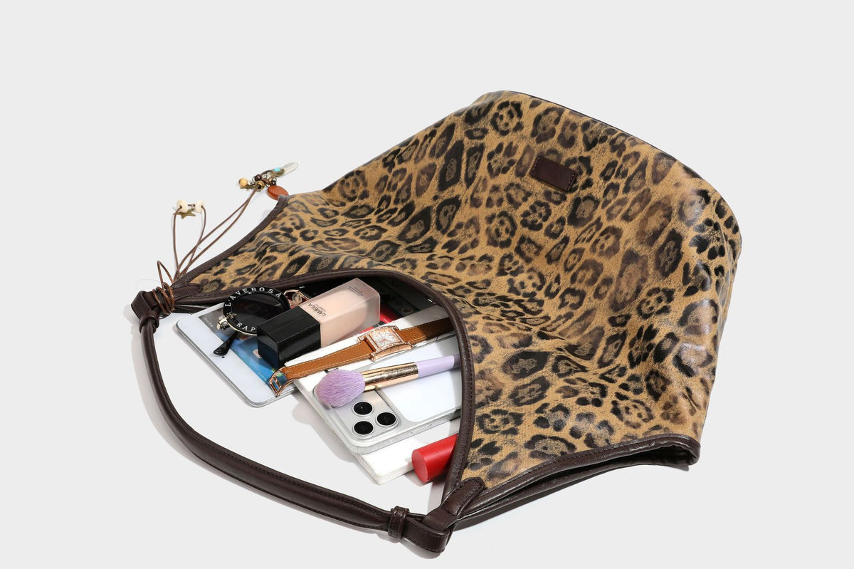 Large slouchy leopard-print shoulder tote bag with glossy tan-and-brown finish, dark brown leather-look trim, single