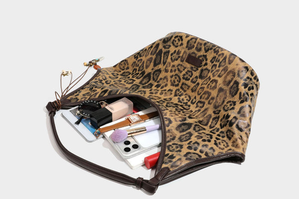Large slouchy leopard-print shoulder tote bag with glossy tan-and-brown finish, dark brown leather-look trim, single