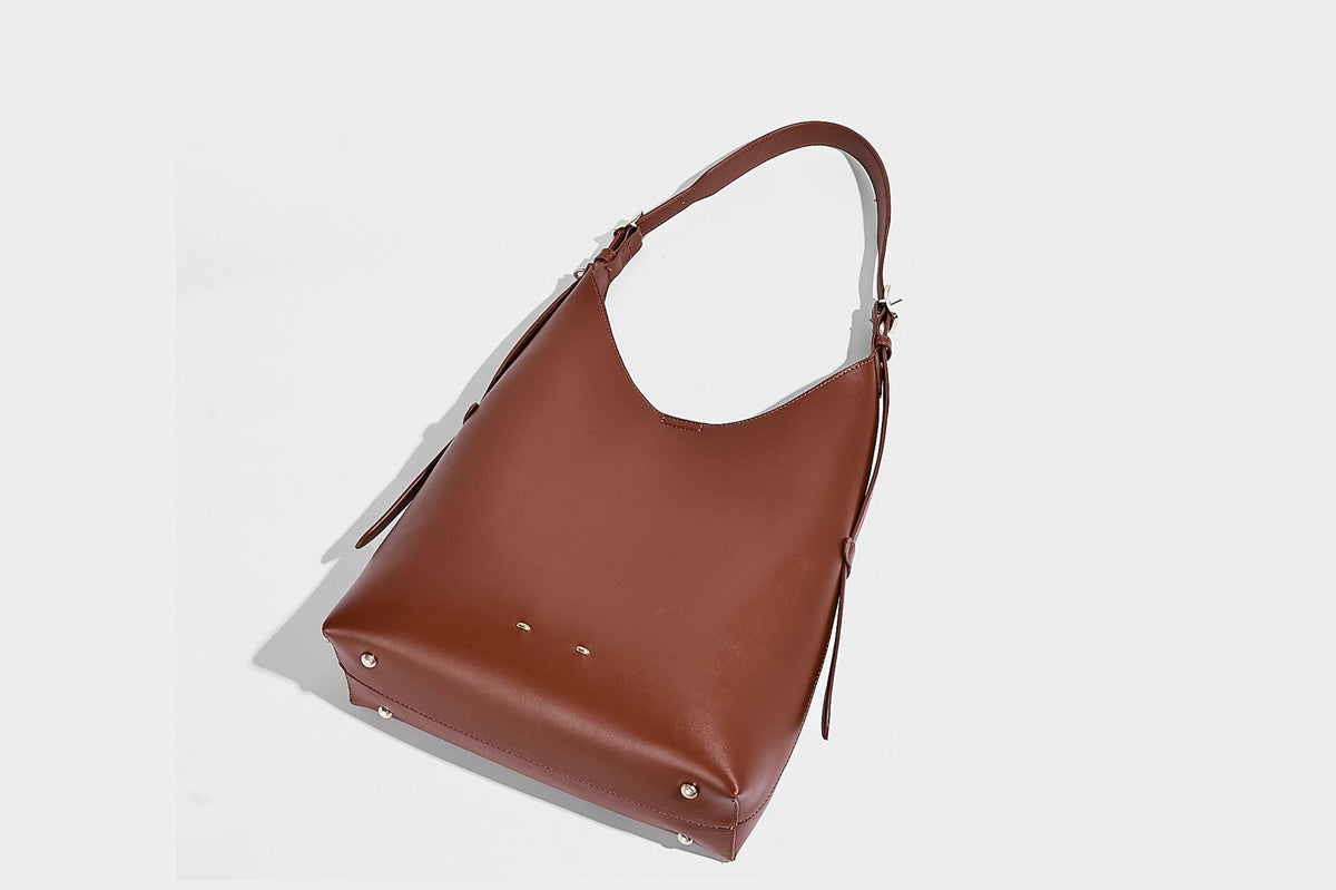 Large open-top hobo shoulder bag in tan leather-look finish with detachable zip pouch and adjustable buckle strap, detail