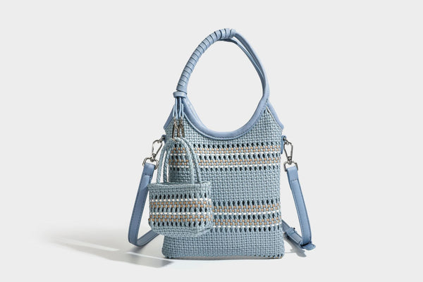 Color-block woven tote bag with rounded leather-look handles, detachable crossbody strap, and matching mini clip-on pouch in