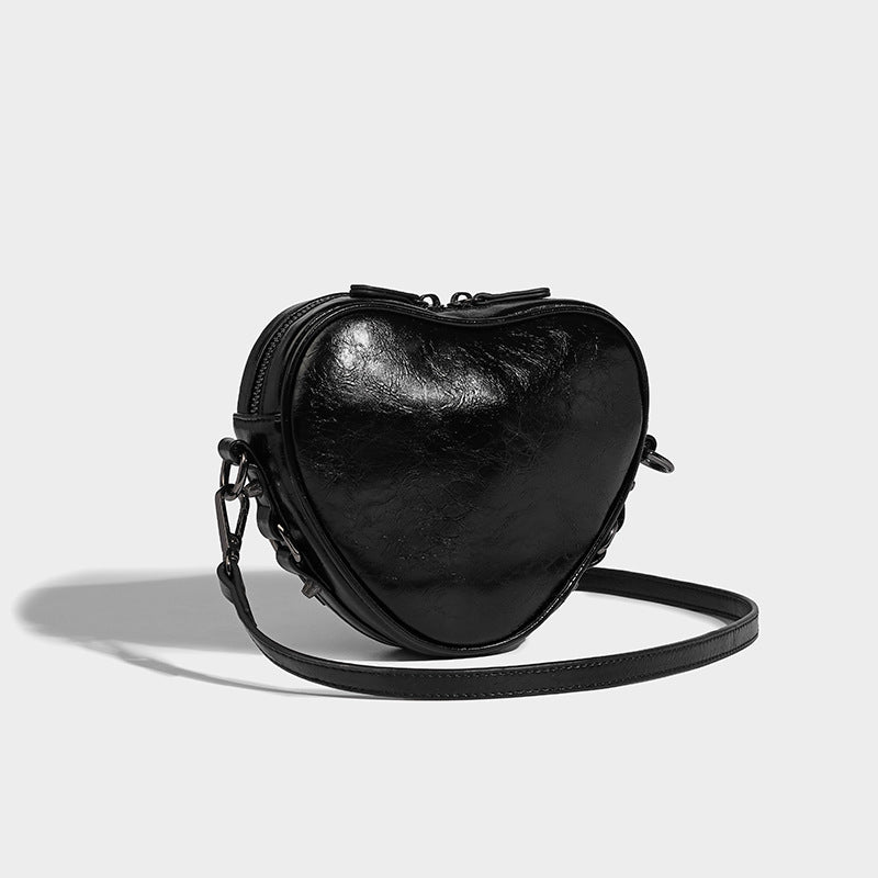 Mini heart-shaped crossbody bag with glossy crinkled finish and moto buckle hardware, detail view 22