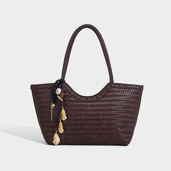 Large open-top woven tote bag with contrasting braided double handles and matching drawstring pouch, front view