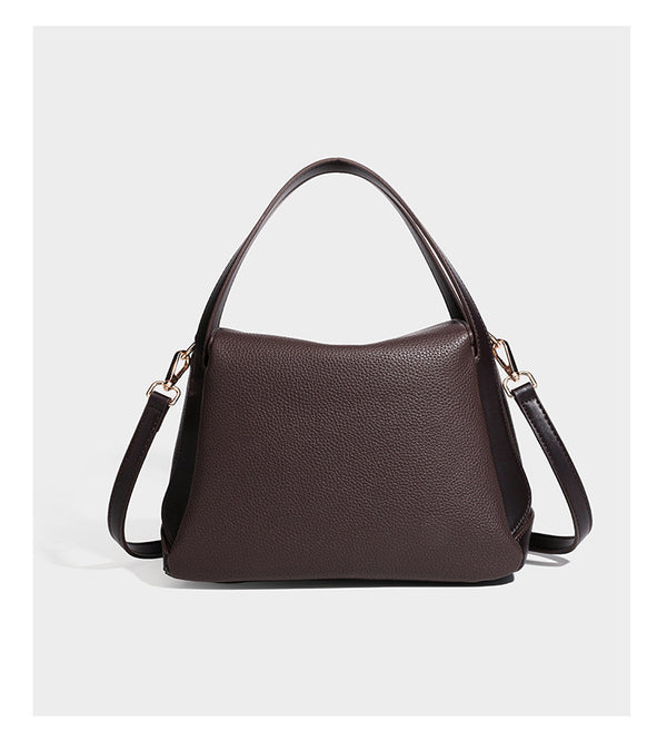 Structured pebbled leather-look shoulder bag with flap top, gold-tone emblem hardware, dual top handles, and detachable