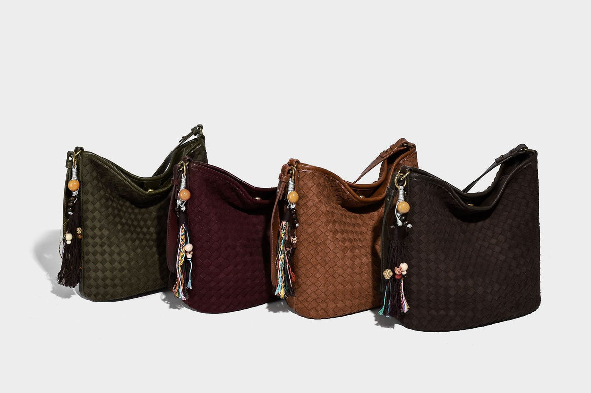 Dark chocolate woven texture hobo shoulder bag with multicolor tassel-and-bead charm and long adjustable strap, detail view