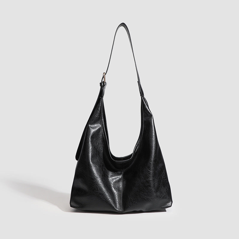 Large slouchy hobo shoulder bag in smooth leather-look finish with adjustable strap and gold-tone hardware, detail view 7