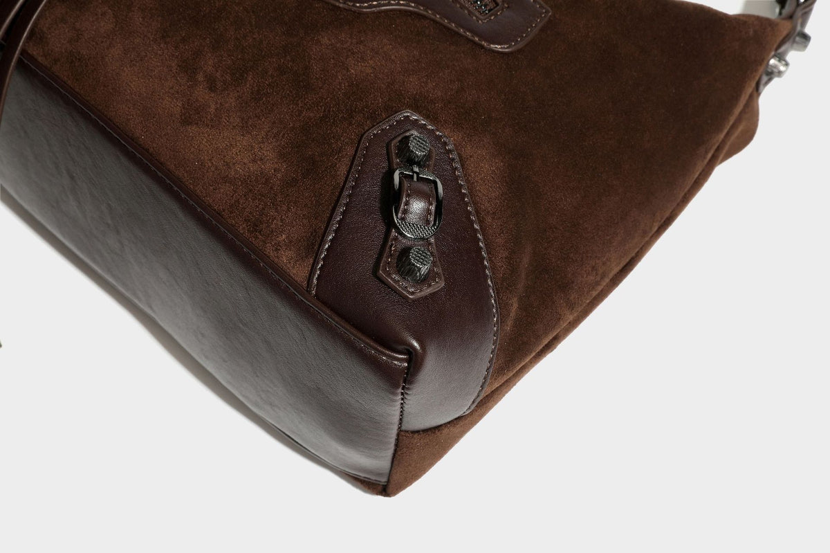 Slouchy suede-finish hobo shoulder bag with dark hardware, exterior zip pocket, tassel ties, and detachable crossbody strap