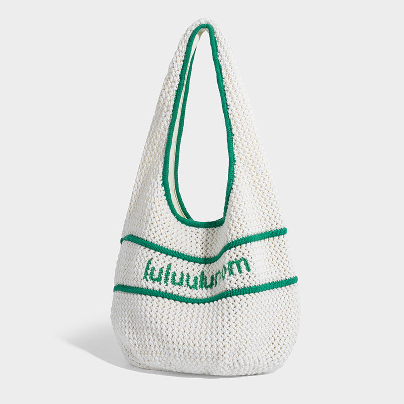 Slouchy chunky crochet shoulder tote bag with contrast trim piping and fabric-lined interior, front view
