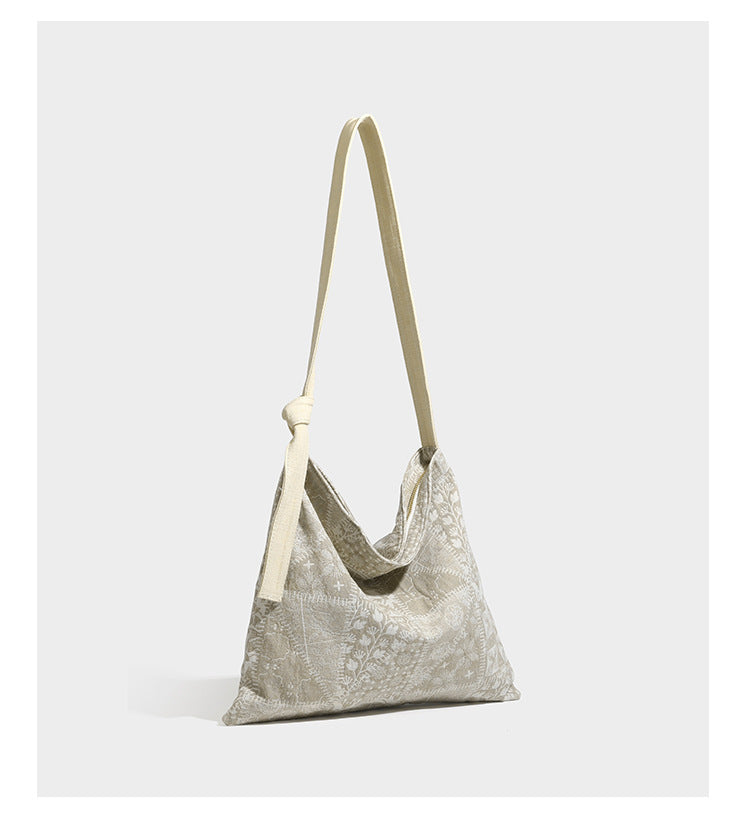 Weich fallende Hobo-Schultertasche aus Canvas mit botanischem Print, langem geknotetem Riemen und Reißverschluss oben, Detailansicht 8