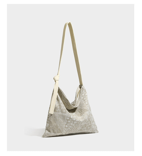 Weich fallende Hobo-Schultertasche aus Canvas mit botanischem Print, langem geknotetem Riemen und Reißverschluss oben, Detailansicht 8