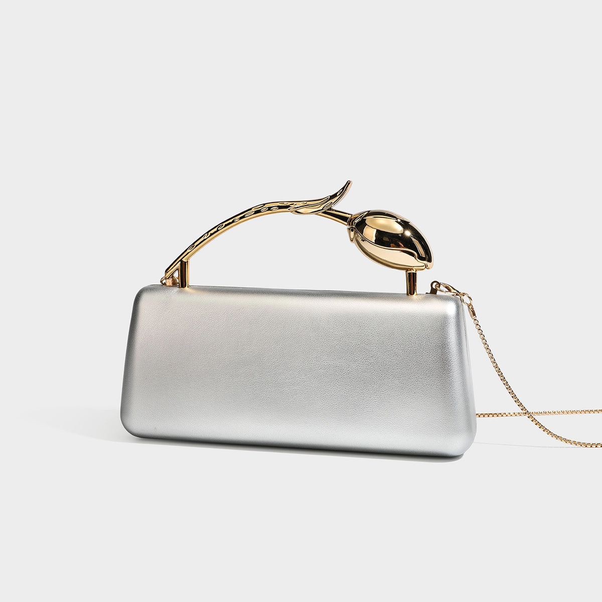Structured rectangular clutch bag with gold-tone rose-bud top handle and detachable chain strap in metallic finish, front