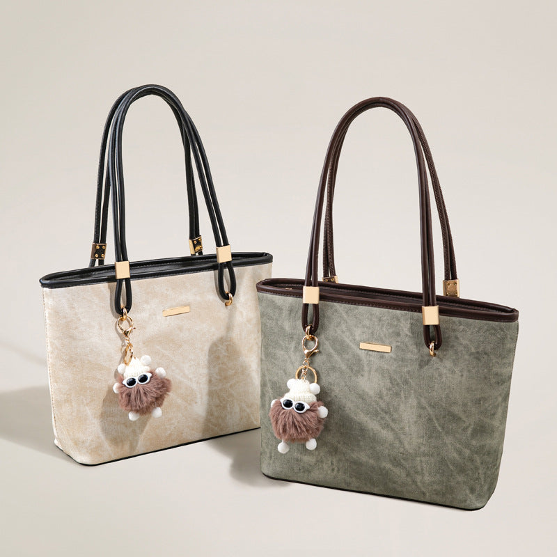 Large structured vintage tote bag in sage green with coffee-brown leather-look trim, gold-tone hardware, and removable plush