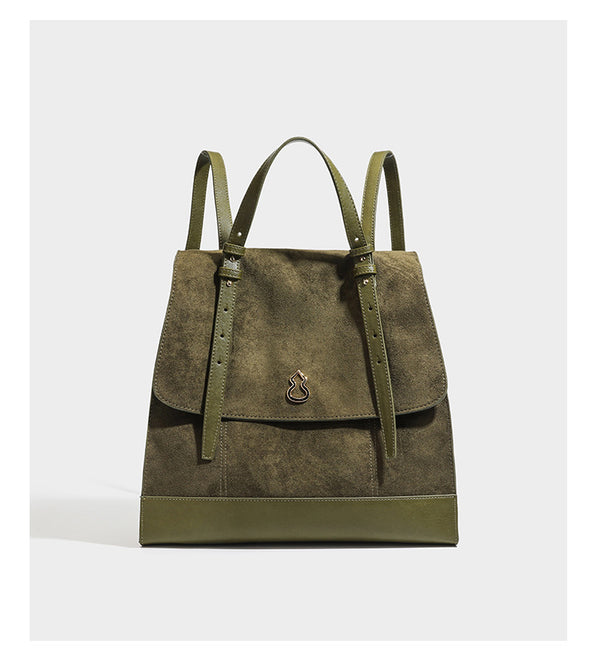 Structured suede-look convertible backpack handbag with flap closure and gold-tone emblem hardware in chocolate brown, detail