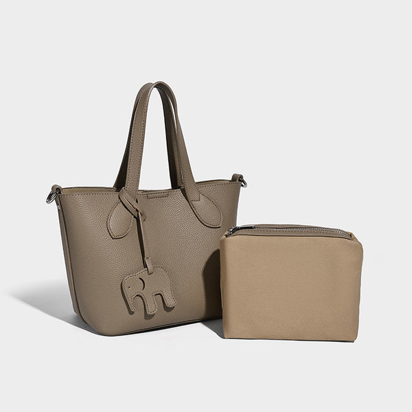 Compact pebbled bucket tote bag with elephant charm, twin top handles, and detachable crossbody strap, front view