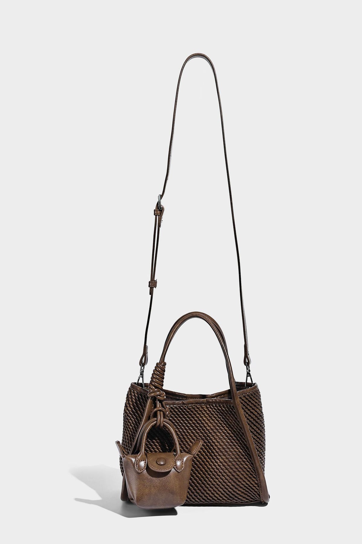 Large structured woven rope-texture tote bag with smooth leather-look trim, knotted dual top handles, detachable mini front