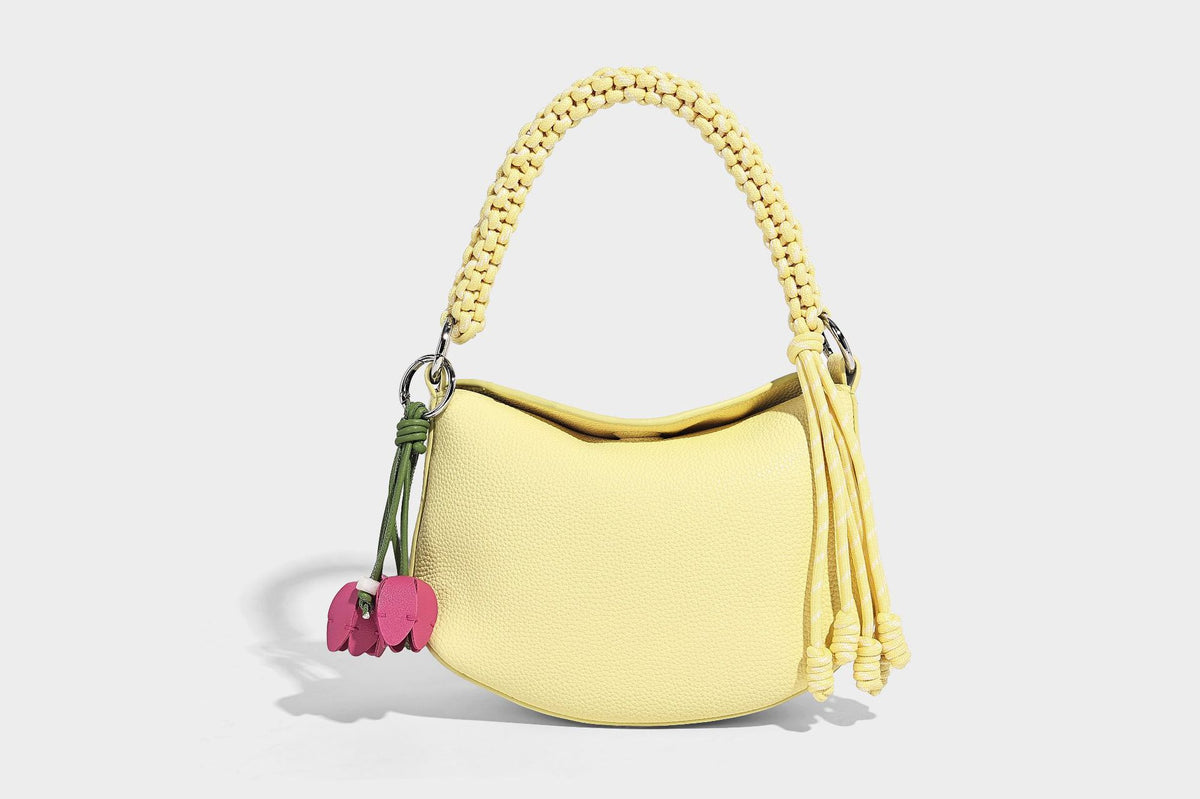 Small crescent half-moon bag in pebbled leather-look finish with braided top handle, silver-tone ring hardware, and, detail