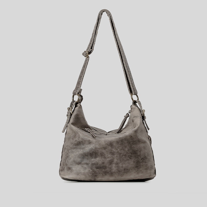 Distressed gunmetal gray hobo shoulder bag with multiple front zip pockets and adjustable crossbody strap, detail view 3