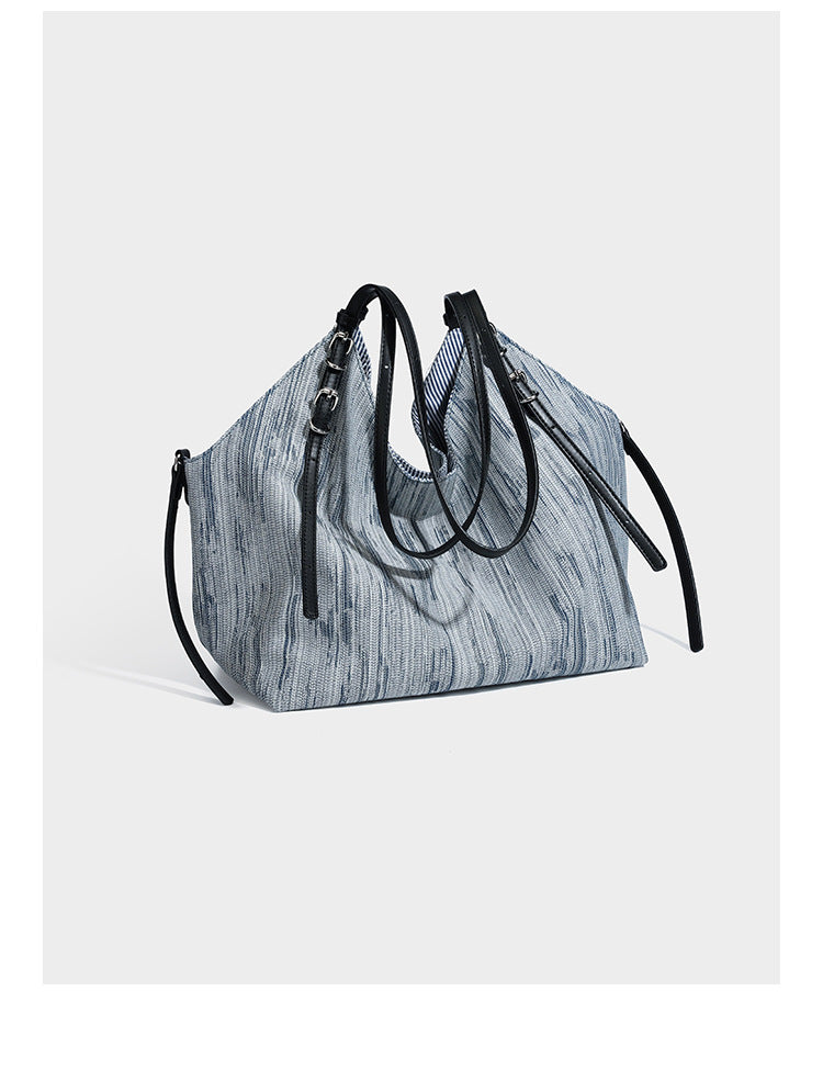 Large slouchy woven-texture shoulder tote bag with slim leather-look straps, side cinch ties, and silver-tone hardware