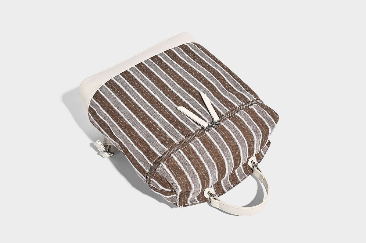 Small structured striped fabric backpack handbag with cream leather-look trim, top handle, and silver-tone hardware, detail