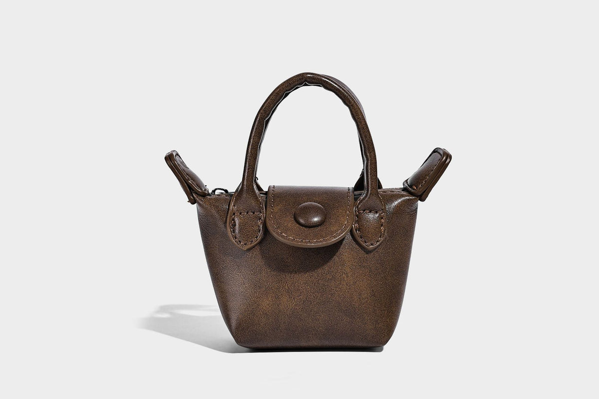 Large structured woven rope-texture tote bag with smooth leather-look trim, knotted dual top handles, detachable mini front