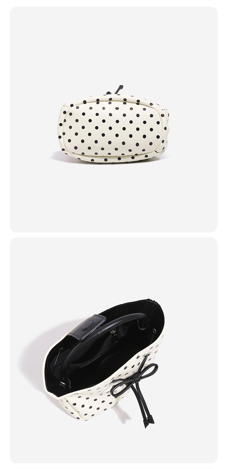 Compact polka-dot drawstring bucket bag with bow closure and rigid top handle, detail view 10