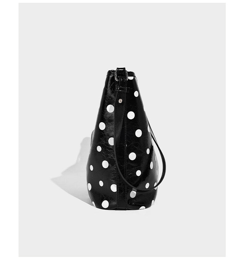 Glossy crinkled polka-dot bucket hobo bag with adjustable crossbody strap and side pouch, detail view 11