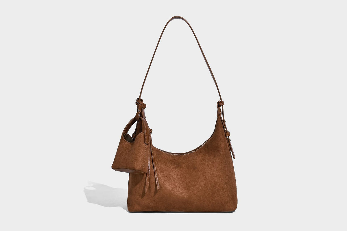 Dark brown suede-look hobo shoulder bag with top zip closure, adjustable strap, and small detachable mini pouch, detail view