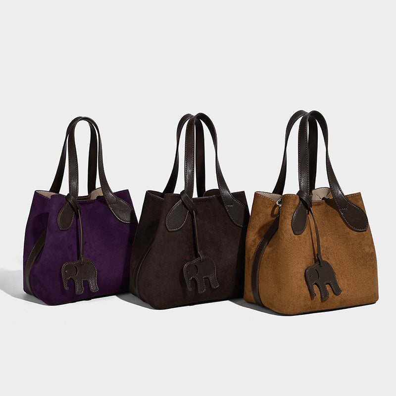 Kleine strukturierte Tote-Handtasche in Wildlederoptik mit Elefanten-Anhänger, zwei Tragegriffen und abnehmbarem Crossbody-Riemen, Detailansicht 2